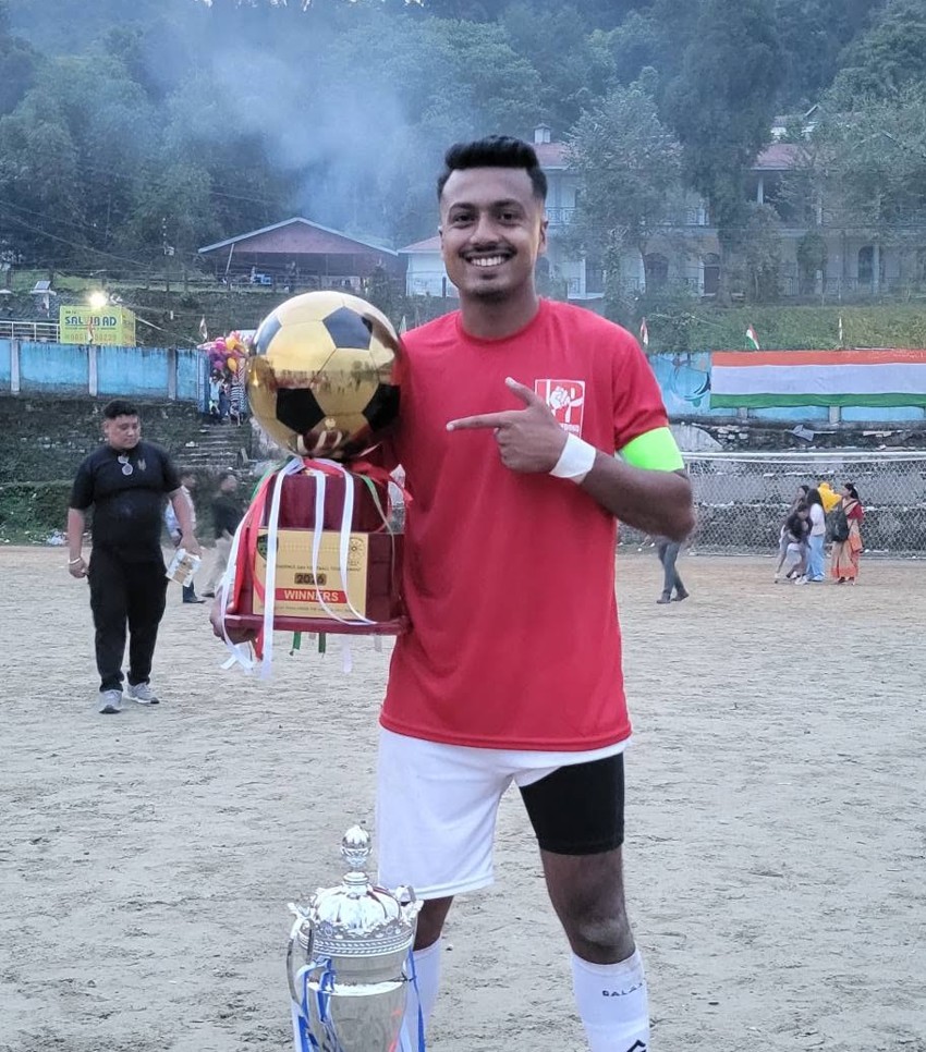 United Pedong player with championship trophies